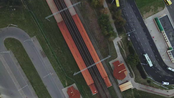 Railway station in the suburbs. A train passes through the station.