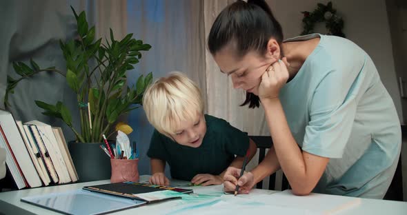 Happy Homeschool Family Make Homework and Mum Help to Son with Art Lesson