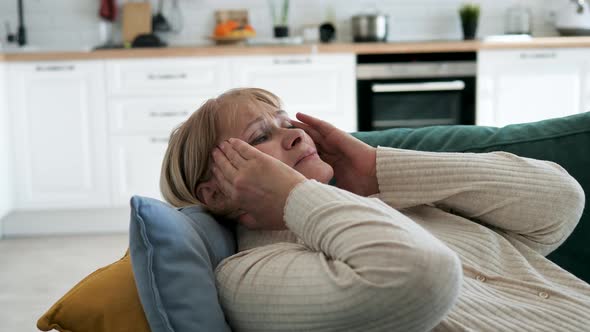 Elderly Mature Woman Is Tormented By Migraines And Headaches