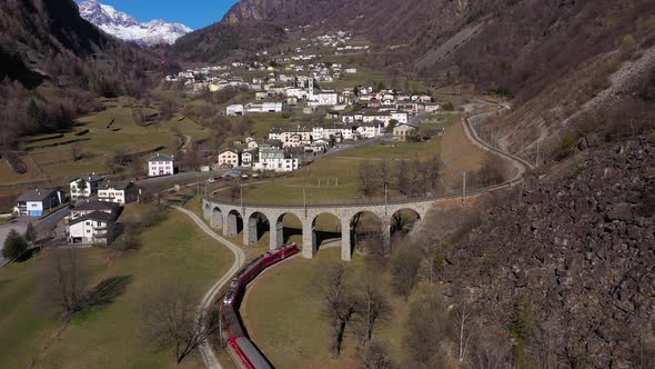 Train on Brusio Spiral Viaduct in Switzerland