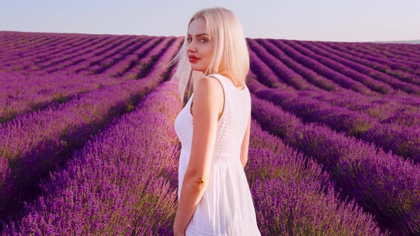 Portrait of a Blonde Woman with Hat in Lavender Fields on Summer