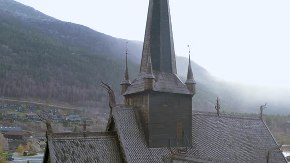 Roof Of A Stave Church In Blizzard During Snowstorm In Autumn In Lom. Norway. close up orbit