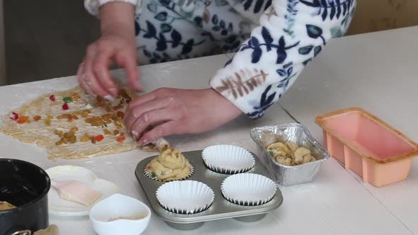 A Woman Prepares A Cruffin With Raisins And Candied Fruits.