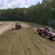 Drone view of tractors tamp the silage in the Silo Trench next to the forest 10 - VideoHive Item for Sale