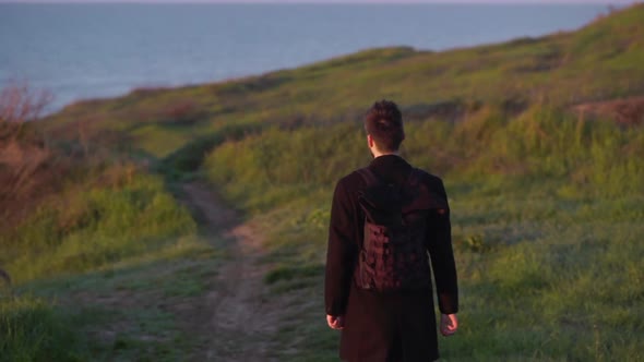 Man Walking Path Grass Looking at the Sea Slow Motion