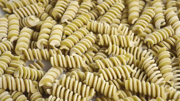 Fusilli Italian uncooked pasta. Green pea vegetable spiral macaroni. Macro