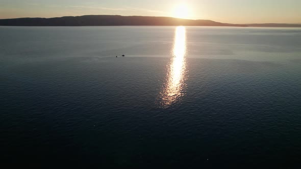 Aerial View of Landscape Sunset Over the Sea Leaves Trail and Glare on the Water