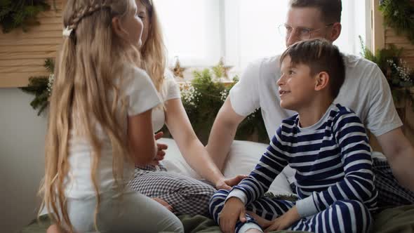 Family spending Christmas morning together in bed. Shot with RED helium camera in 8K