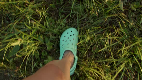 Women's Feet in Shoes Go on the Grass Pov Look