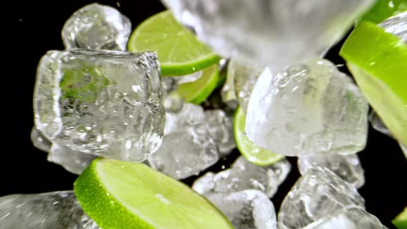 Super Slow Motion Shot of Lime Slices and Ice Cubes Flying Towards Camera at 1000 Fps