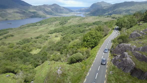 Aerial video of Motor bikes and cars traveling along the renowned 'Ring of Kerry', part of the touri