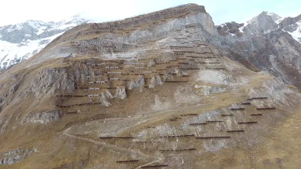 unbelievable number of avalanche protection structures on a steep green mountain in the swiss mounta