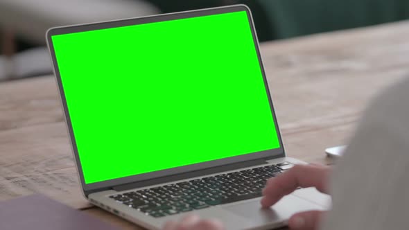 Man using Laptop with Green Screen