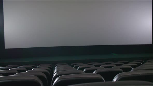 Empty Movie Theater with Black Chairs