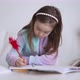Glad Girl Doing Homework and Smiling - VideoHive Item for Sale