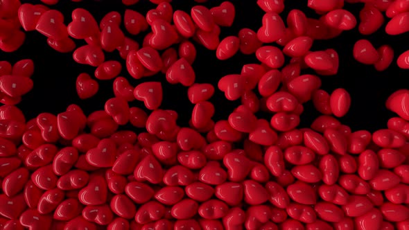 Falling Dynamic Red Hearts Filling the Screen on Isolated Black Background