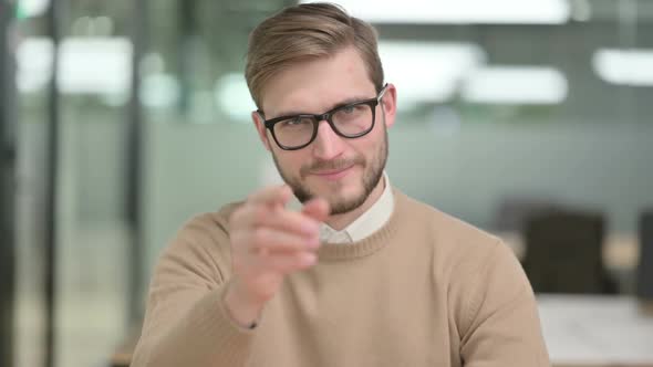 Young Creative Man Pointing at the Camera and Inviting