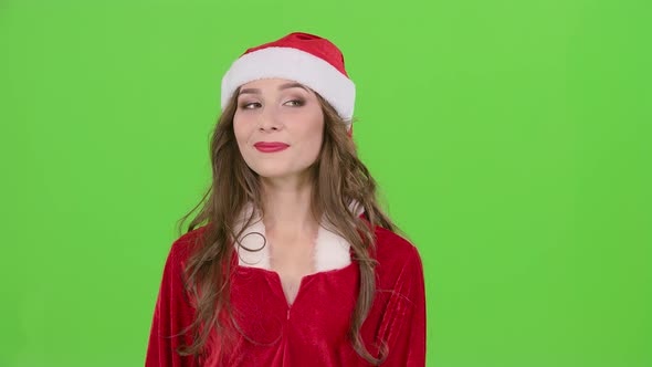 Girl in the Red Suit of the Snow Maiden Winks and Shows Her Finger Ok. Green Screen. Close Up. Slow