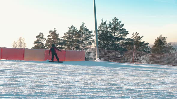 People Snowboadring Down the Mountain