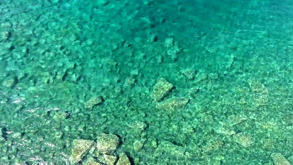 Clear and Shallow Sea Water of the Cove Surrounded by Stone and Rocky Coastline