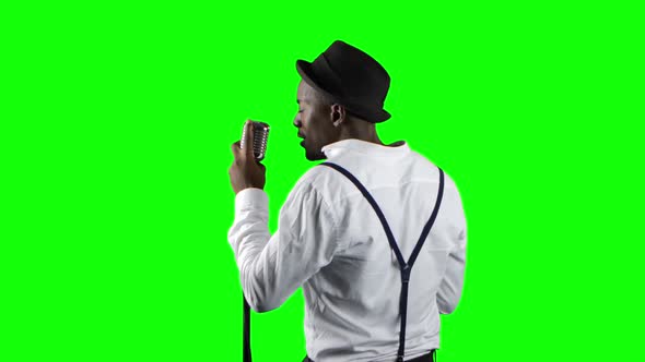 Singer the View From the Back Sings Into a Retro Microphone and Dancing Near It. Green Screen. Close