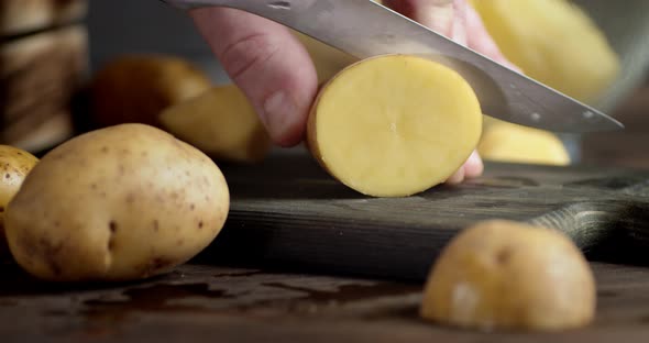 Male Hand Cut From Potatoes Round Piece. 