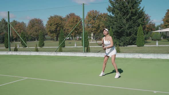 Slow Motion Professional Female Tennis Player Hits the Ball with a Racket Practice Game on the