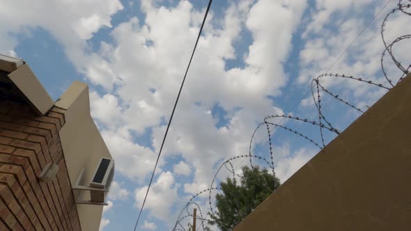 time lapse of barbed wire and a air conditioning unit with clouds