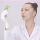 Young Attractive Scientist Looks at Plant Leaf on Laboratory White Background - VideoHive Item for Sale
