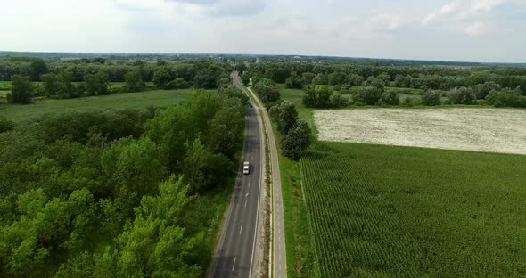 Cars on Road with Farming Landscape 