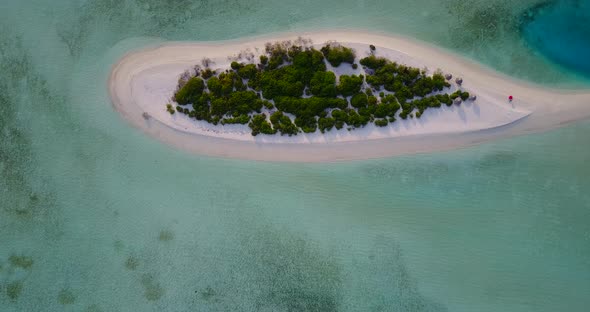 Wide angle aerial clean view of a summer white paradise sand beach and aqua turquoise water backgrou