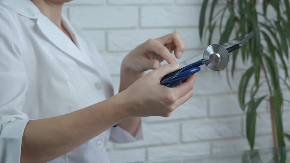 Medical assistant on laptop.