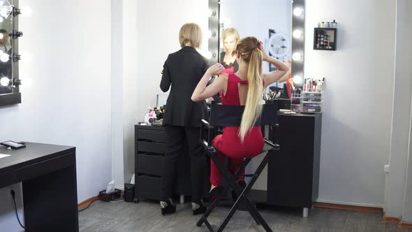 Makeup Artist Applying Cosmetic Tonal Foundation on the Face Using Brush and Finishing the Make