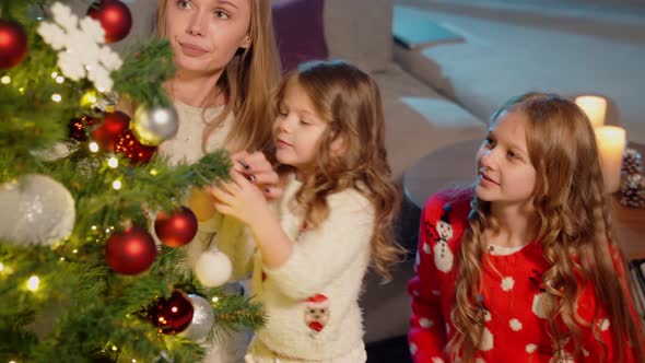 Girls and Woman Having Fun While Decorating Christmas Tree