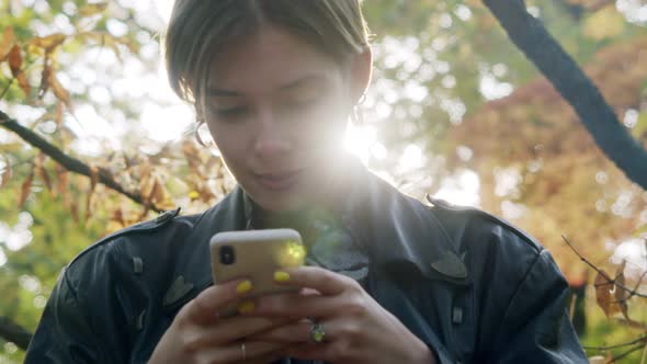 Portrait of a Stylish Woman with Short Hair and Wearing a Vintage Leather Jacket Looking at the