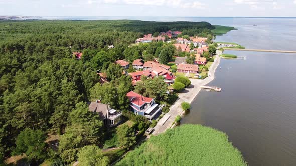 Small luxury coastal town of Pervalka in Neringa region, Lithuania. Aerial fly over view