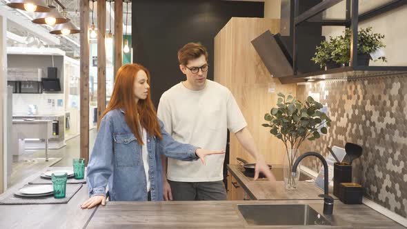 Portrait of Young Couple Dreaming About New Kitchen, Home Design