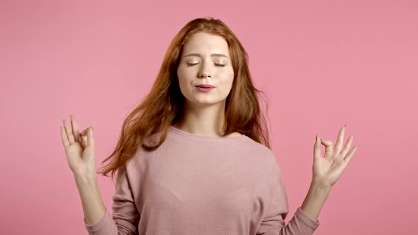 Calm Girl Relaxing, Meditating. Woman Calms Down, Breathes Deeply with Mudra Om on Pink Studio