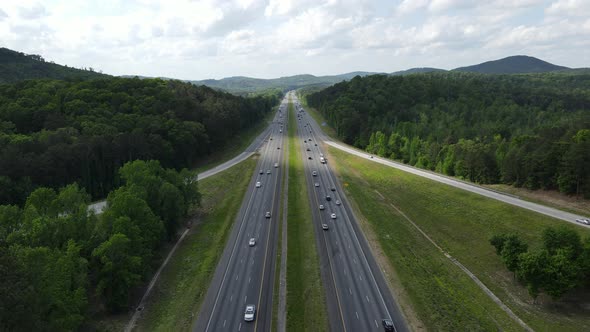 Camera ising towards oncoming traffic as it passes on the interstate. 4k 24fps.