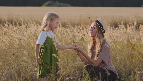 Ecology Agronomy Young Caucasian Woman Mother Wears Hat Sitting in Wheat Field with Little Daughter