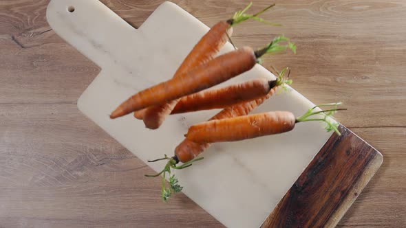 Carrot Falls in Slow Motion To the Rock Board on the Table, Falling Vegetables, Food in Super Slow