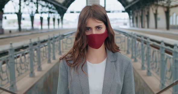 Portrait of Millennial Attarctive Girl in Cotton Face Mask Looking To Camera. Crop View of Serious