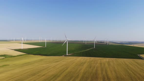 Aerial view of a wind farm against the blue sky on a summer sunny day