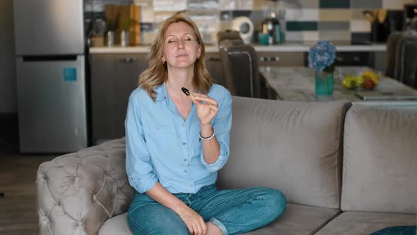 Woman Enjoying Incense Stick Waving It in Kitchen Rbbro