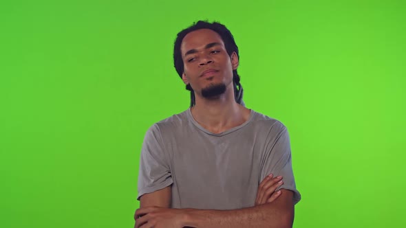 Young Disgruntled African American Man Shows Stop Gesture Stands in Green Studio