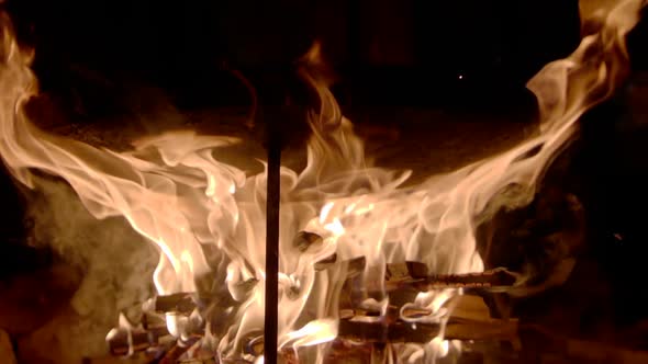 Cast Iron Frying Pan Is Fired in Burning Coals To Burn Out the Oil