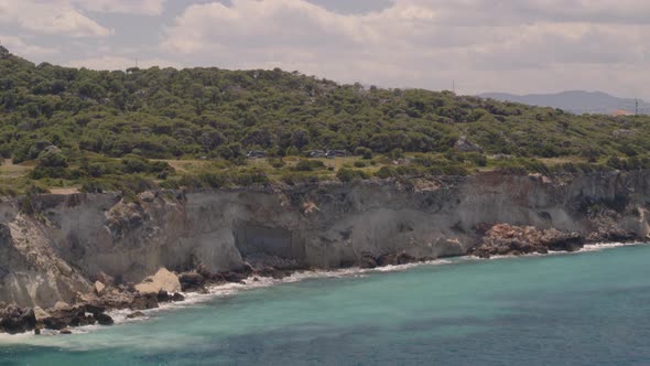 Flying Towards Cliffs Cascading into the Ionian Sea Water Near Loutraki Greece