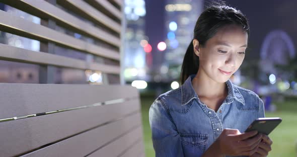 Young woman use of mobile phone in city