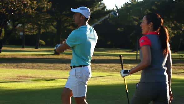 Excited golf players giving high five