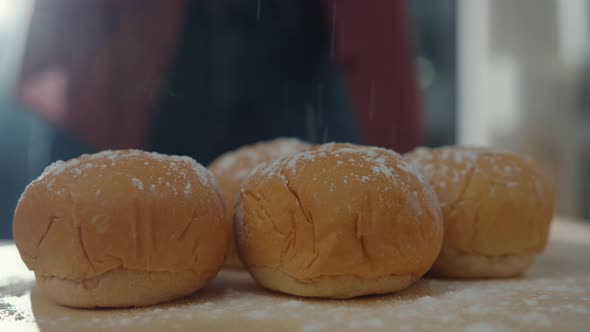 Hands of Asian woman chef prepares dough with flour cooking whole grain bread on kitchen table